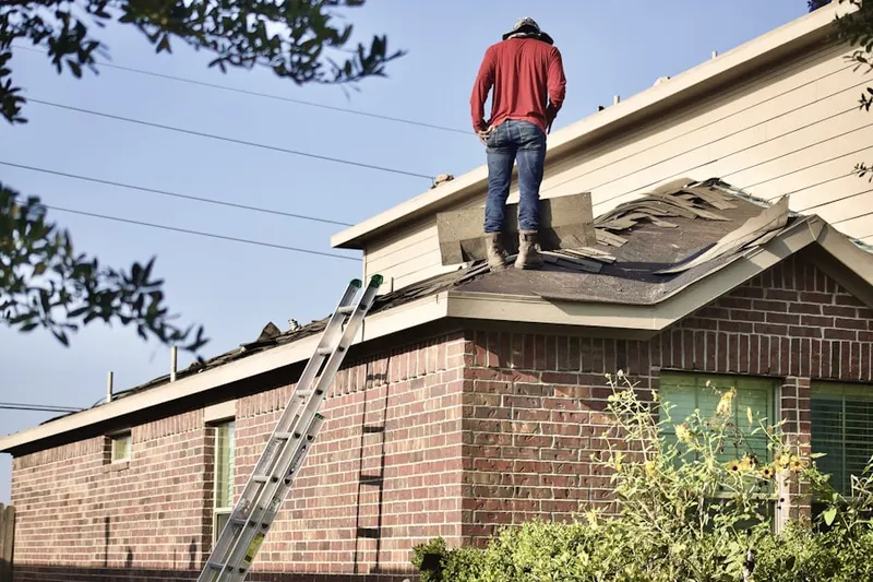 Professional roofer working on a residential roof in Dulls Corner